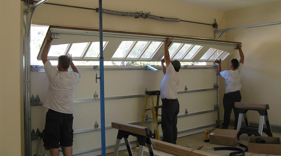 men installing garage door