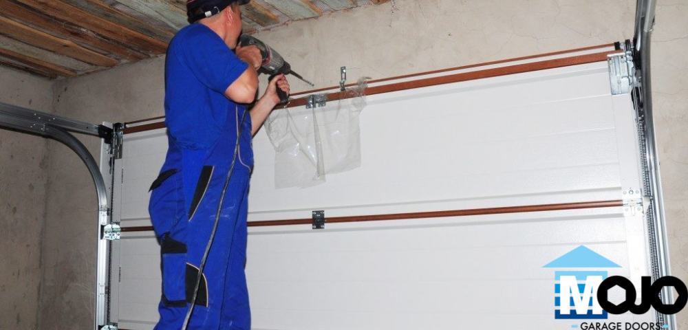 man fixing garage door